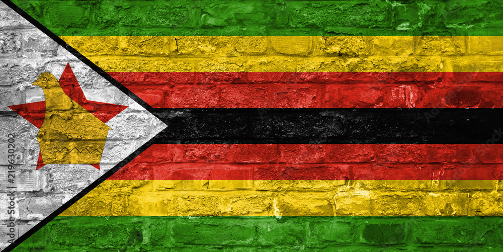 Flag of Zimbabwe over an old brick wall background, surface