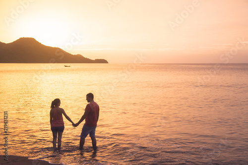 Couple at Matapalo beach in Guanacaste in Costa Rica at sunset photo