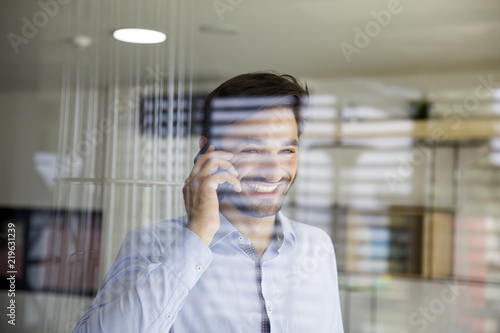 Young man using mobile phon...