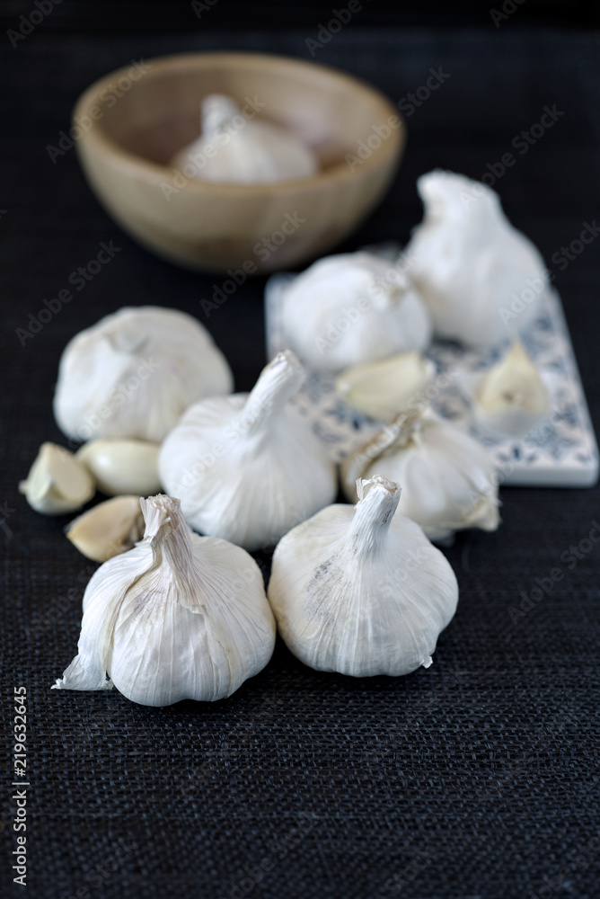 group of garlic heads on black background group of garlic heads on black background