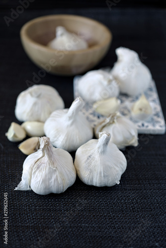group of garlic heads on black background