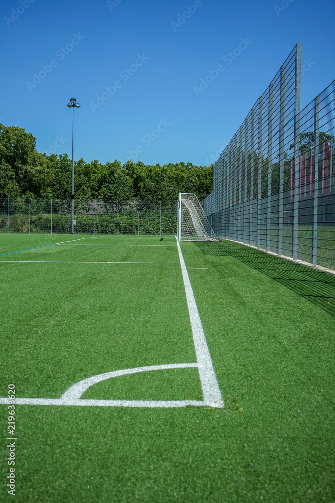 white lines and grean plastic grass on soccer or football field