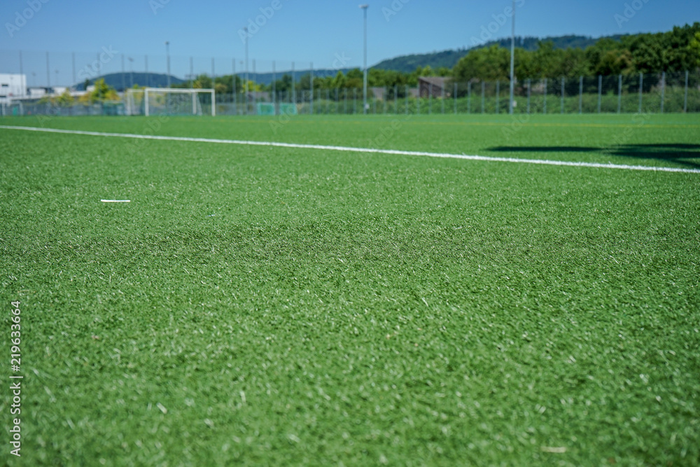 Fototapeta premium white lines and grean plastic grass on soccer or football field
