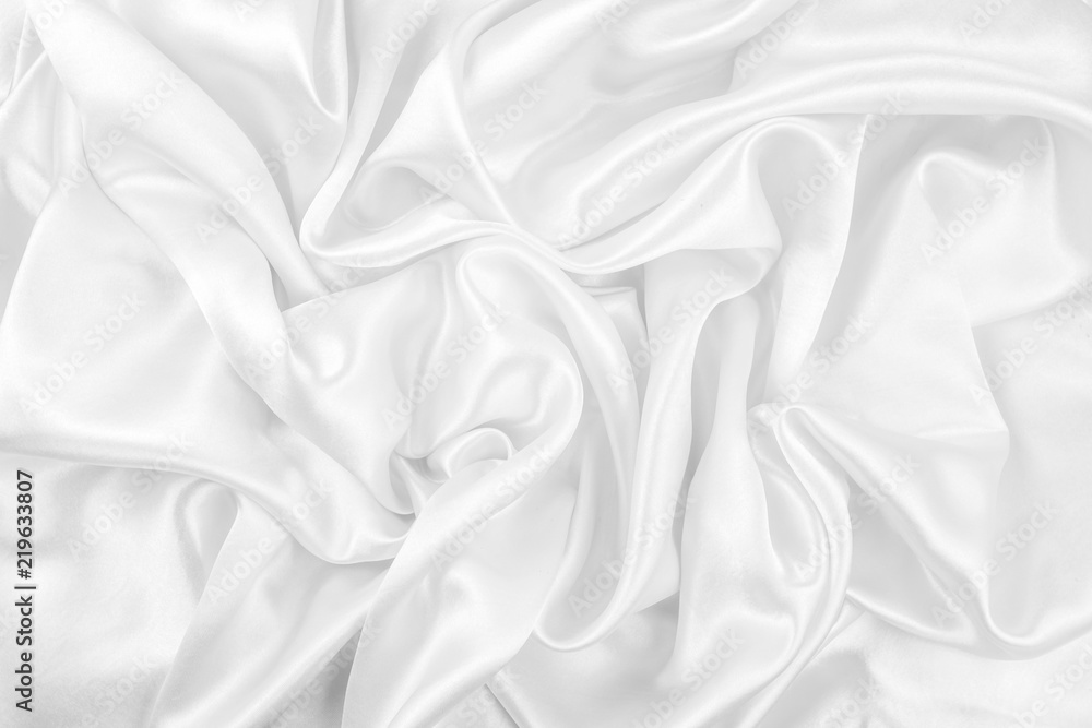Luxurious of smooth white silk or satin fabric texture background Luxurious of smooth white silk or satin fabric texture background