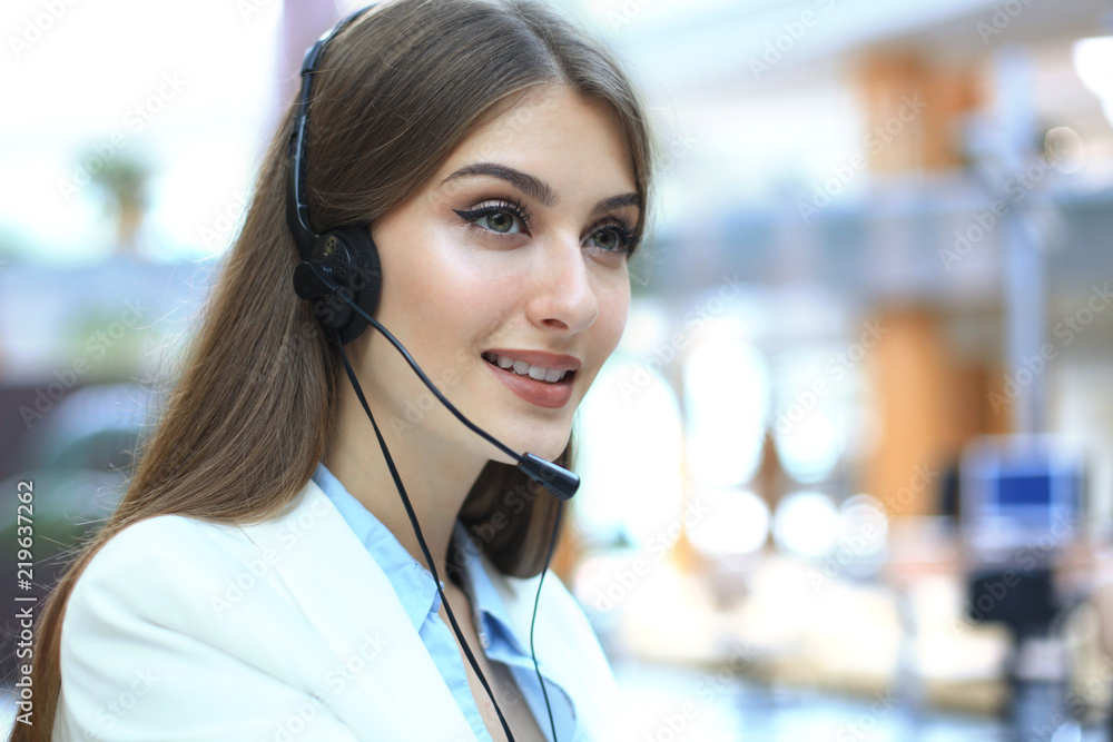 Female customer support operator with headset and smiling. Female customer support operator with headset and smiling.