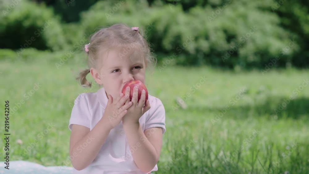 Healthy Nutrition. Child Eating Juicy Apple Outdoors Healthy Nutrition. Child Eating Juicy Apple Outdoors