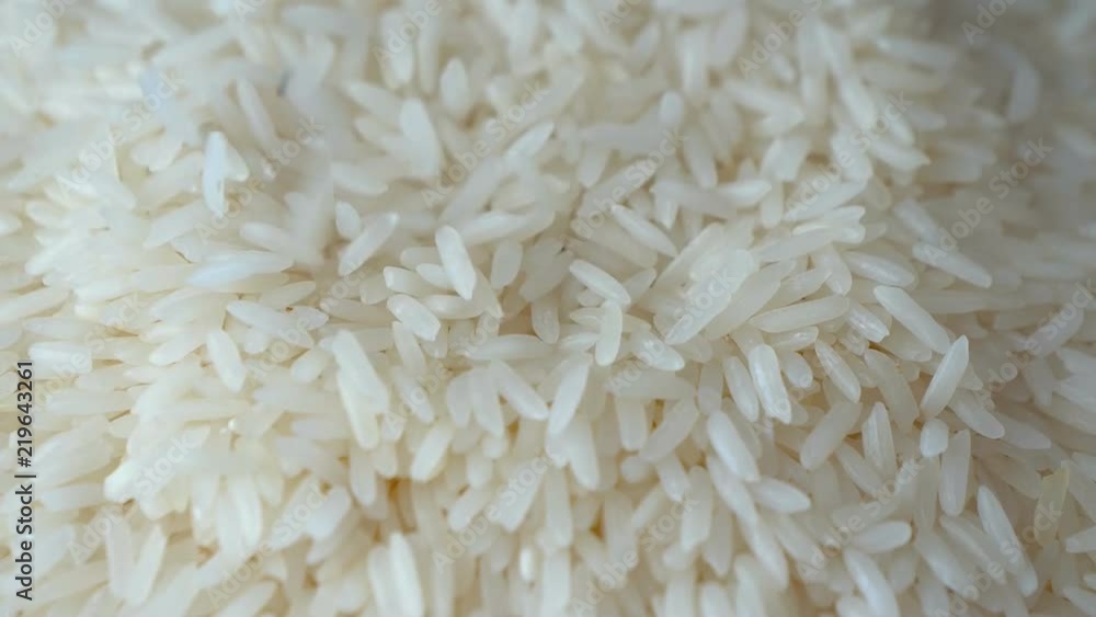 Slow motion of close up falling raw rice / uncook rice. (High speed video) Slow motion of close up falling raw rice / uncook rice. (High speed video)