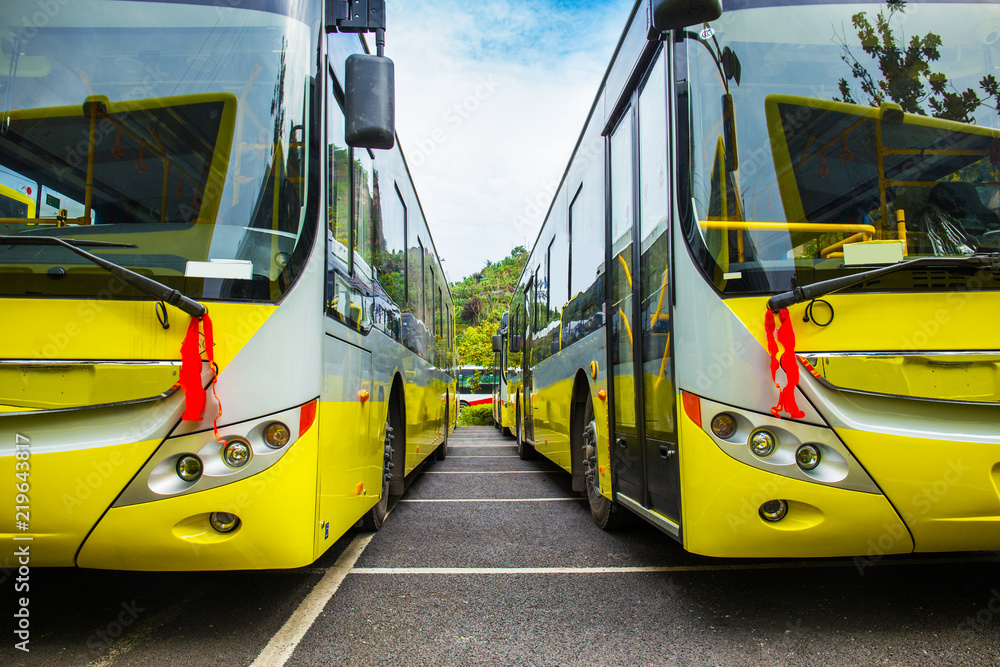 New electric bus parked in open-air parking lot