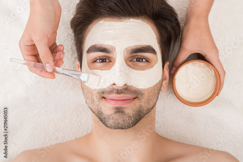 Man having cosmetic mask in spa salon