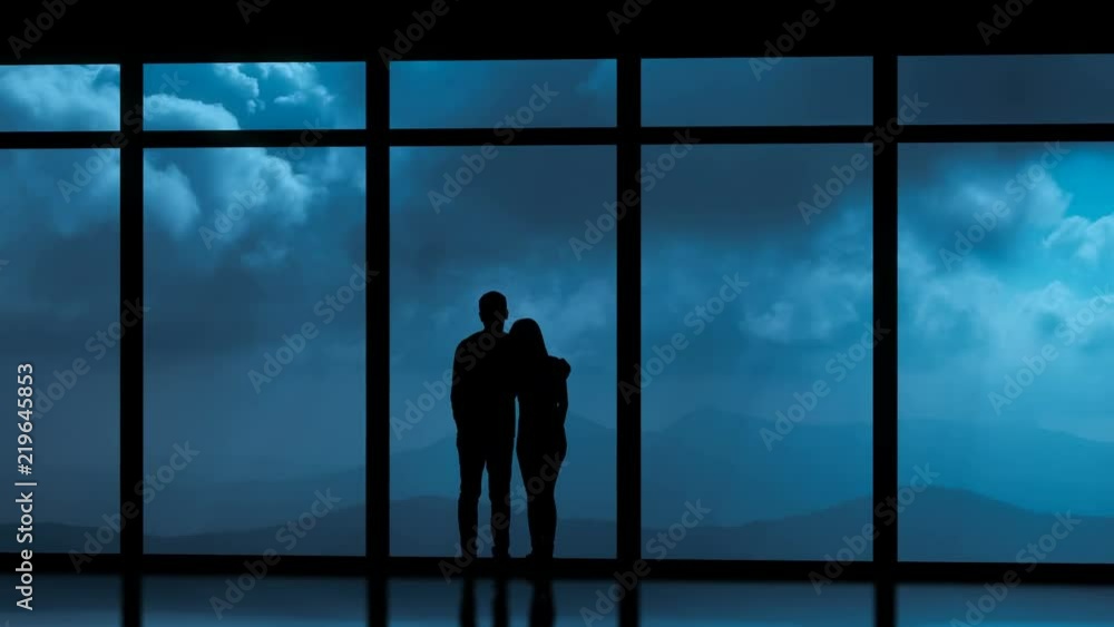The couple standing near windows on a cloud stream background. time lapse The couple standing near windows on a cloud stream background. time lapse