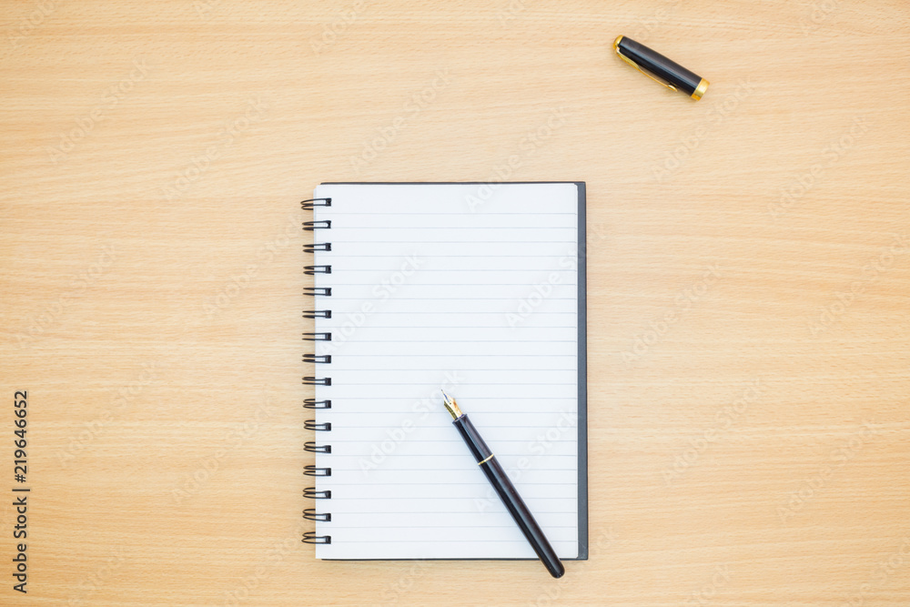Flat lay photography. Empty notebook and a pen on a wooden table. Write memo office idea concept. Flat lay photography. Empty notebook and a pen on a wooden table. Write memo office idea concept.