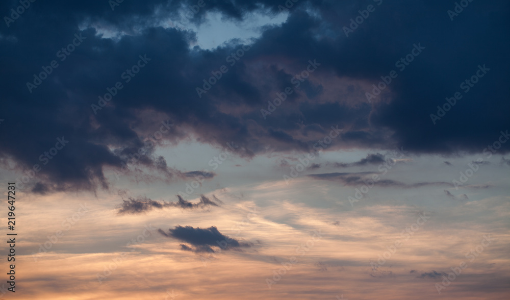 Abstract nature background. Dramatic and moody pink, purple and blue cloudy sunset sky.