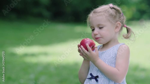 Healthy Nutrition. Child Eating Juicy Apple Outdoors