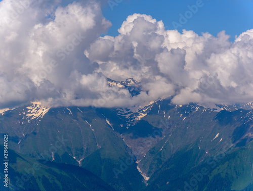 Mountain peaks in the clouds. Mountain ridge