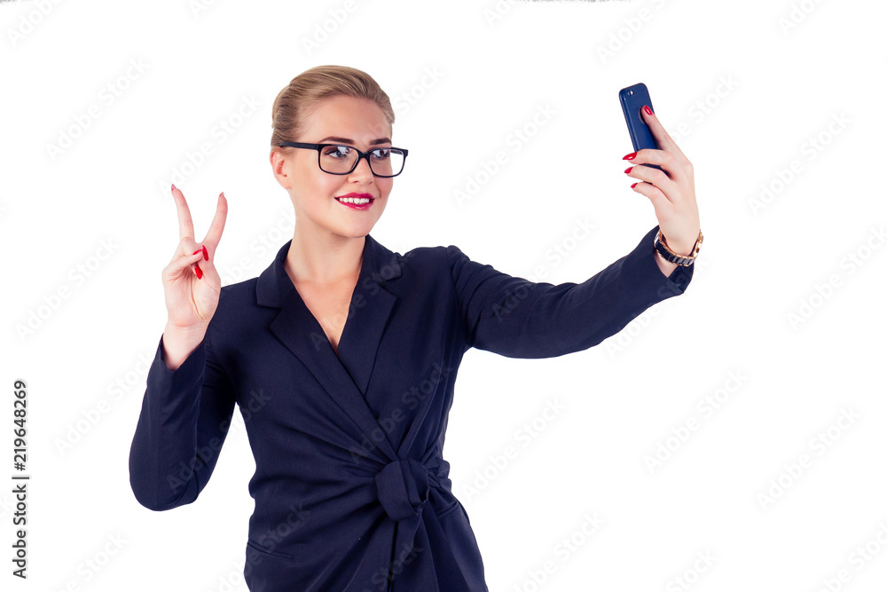 portrait of successful businesswoman glasses blonde hairstyle perfect make-up red lips in stylish black suit taking selfie photo smartphone studio white isolate. portrait of successful businesswoman glasses blonde hairstyle perfect make-up red lips in stylish black suit taking selfie photo smartphone studio white isolate.