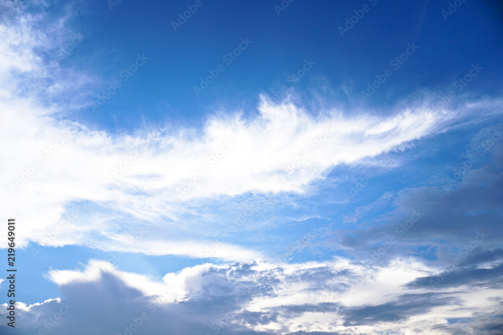 Obraz premium Beautiful white and gray clouds against the blue sky. Summer and autumn day with a view from the airplane to the atmosphere. Stock Photo for design