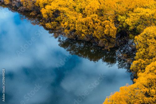 Stunning view of the Diamond lake with the reflection of the mountain and yellow trees in autumn. Wanaka  New Zealand.