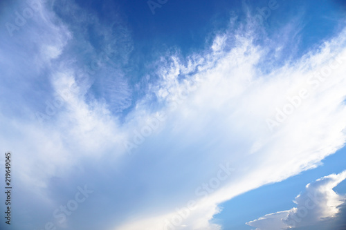 Beautiful white and gray clouds against the blue sky. Summer and autumn day with a view from the airplane to the atmosphere. Stock Photo for design
