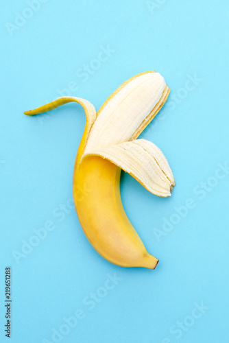 Yellow ripe banana peeled half
