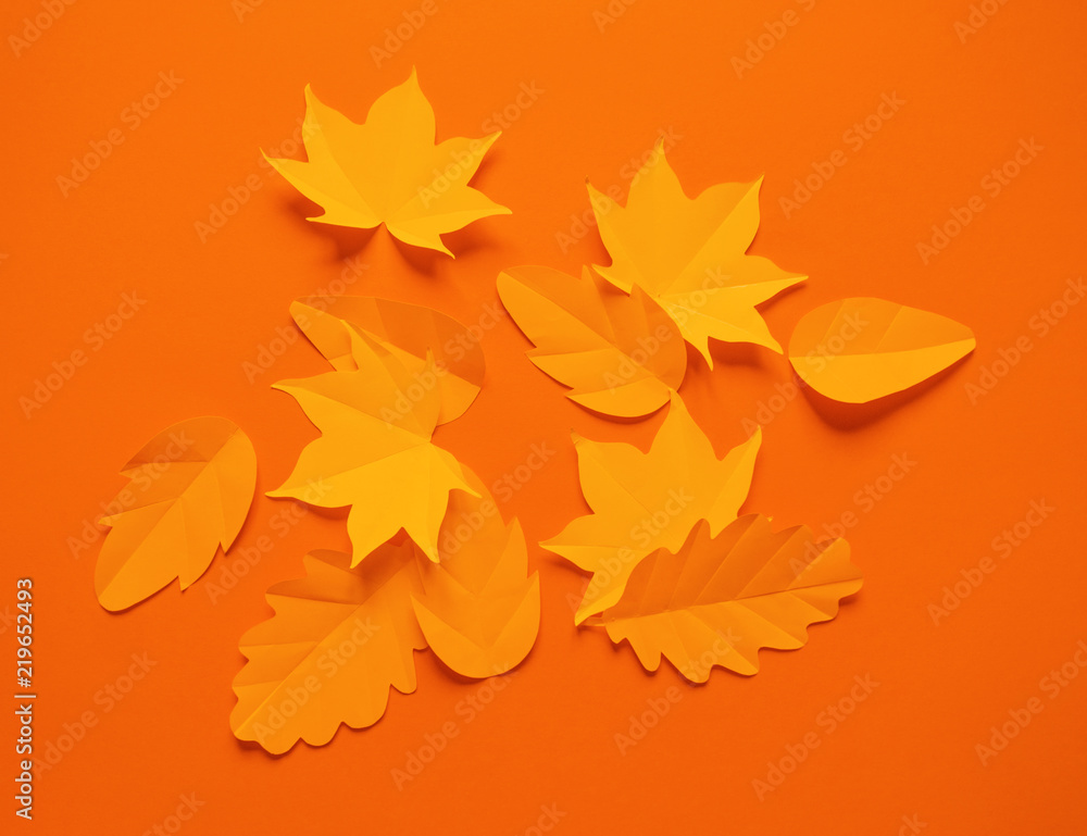 Autumn leaves made from paper orange background