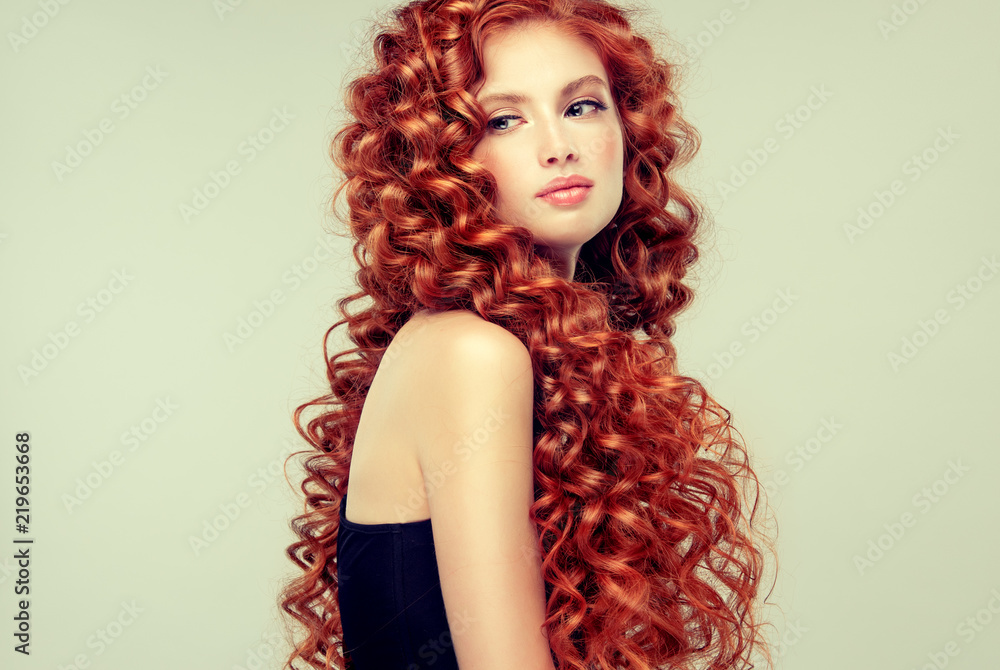 Beautiful model girl with long red curly hair .Red head . Care and beauty  hair products Stock Photo | Adobe Stock
