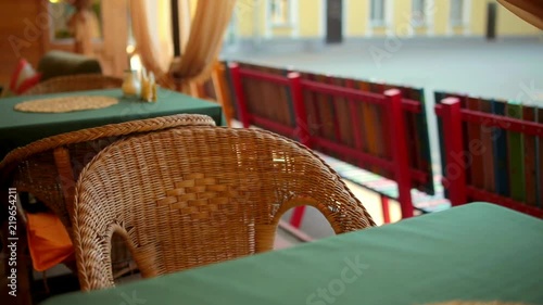 Wicker chair in an empty cafe. The camera moves photo