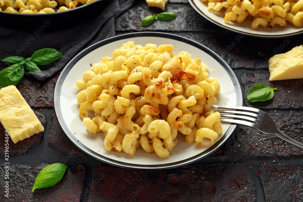 Homemade baked macaroni and cheese with cheddar served on plate Homemade baked macaroni and cheese with cheddar served on plate