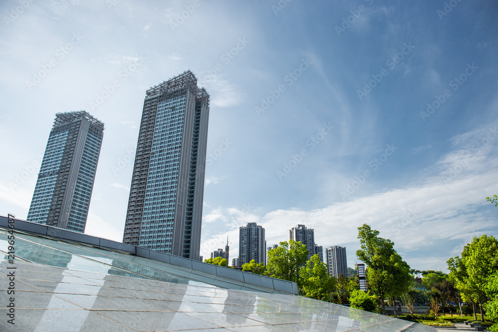 Looking up from the park to see the tall buildings in the city not far away Looking up from the park to see the tall buildings in the city not far away