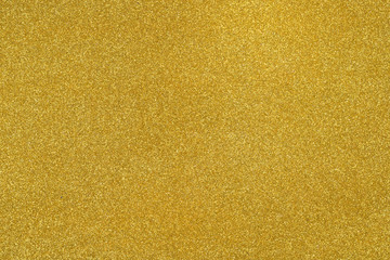 Shiny hot yellow gold foil golden color glitter decorative texture paper: Bright brilliant festive metallic textured empty wallpaper backdrop: Tin metal material for holiday craft design decoration