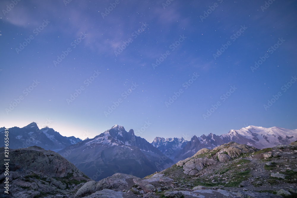 Snowy Mont-Blanc Mountains Range Peaks under Blue Starry Sky at Dawn.