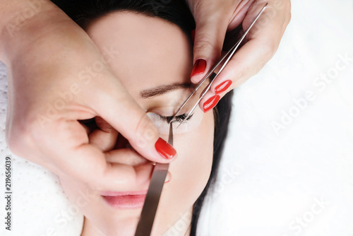 Eyelash Extension Procedure. Woman Eye with Long Eyelashes. Lashes  close up  macro  selective focus