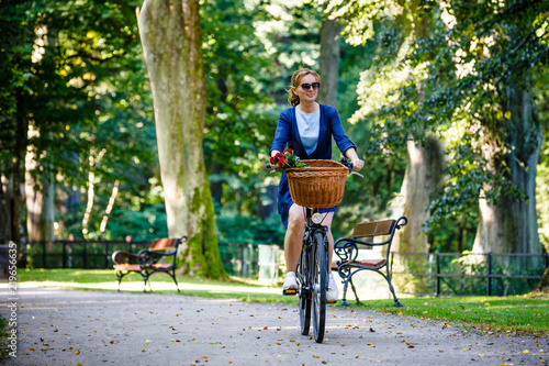 Urban biking - woman and bike in city park