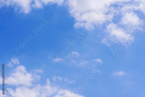 The vast blue sky with large group of fluffy clouds in sunny day of summer, peaceful skies background