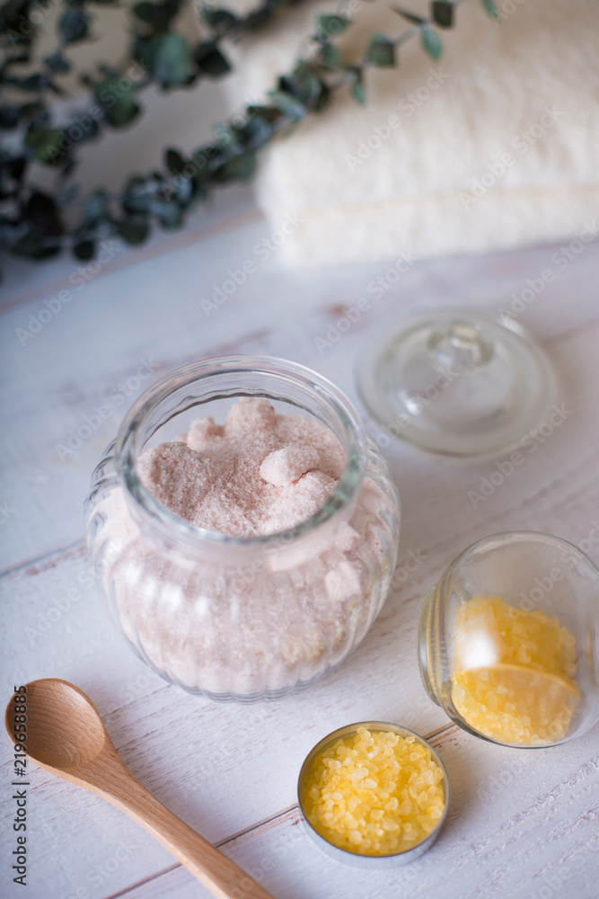 pink and yellow bath salt on white wooden table pink and yellow bath salt on white wooden table