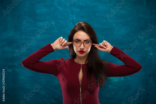 Beautiful brunette woman wearing stylish eyeglasses posing in studio