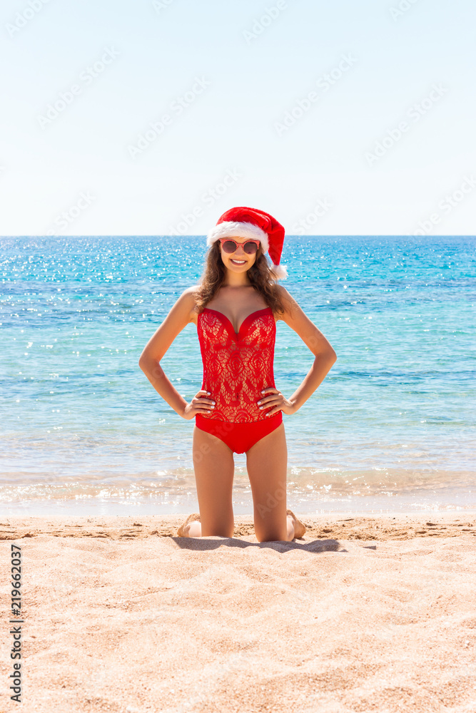 christmas holiday vacation at the beach. girl in santa hat on the sea christmas holiday vacation at the beach. girl in santa hat on the sea