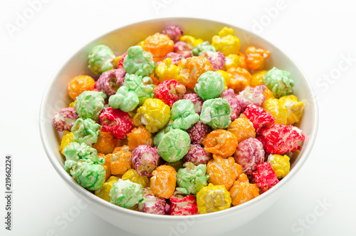 Colorful sweet popcorn from a shop in white bowl. Delicious treat.