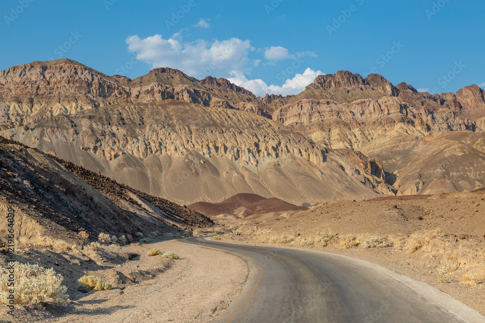 A road in Death Valley, leading towards rugged mountains
