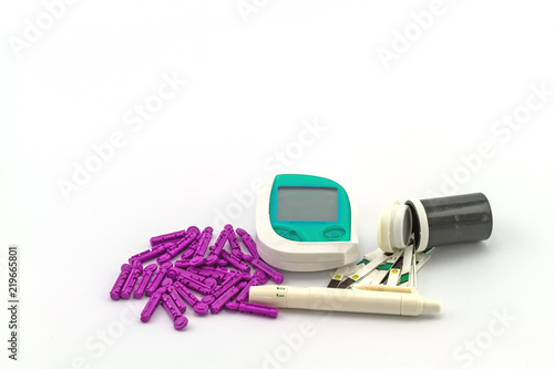 Many strip test of blood glucose meter, the blood sugar value is measured on a finger on white background