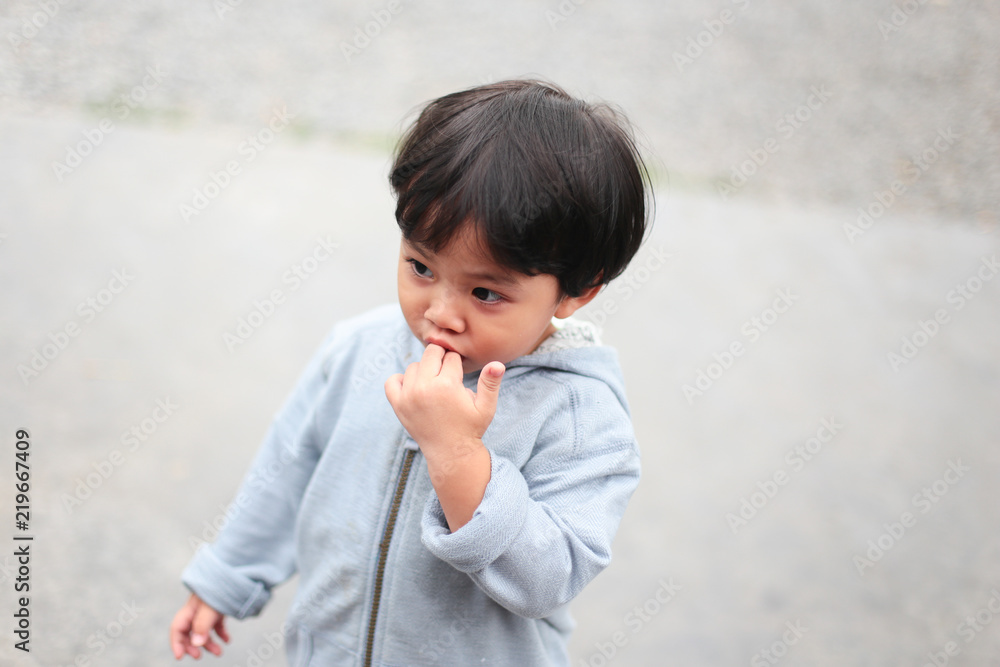 Little Asian boy walking in street in Thailand Little Asian boy walking in street in Thailand