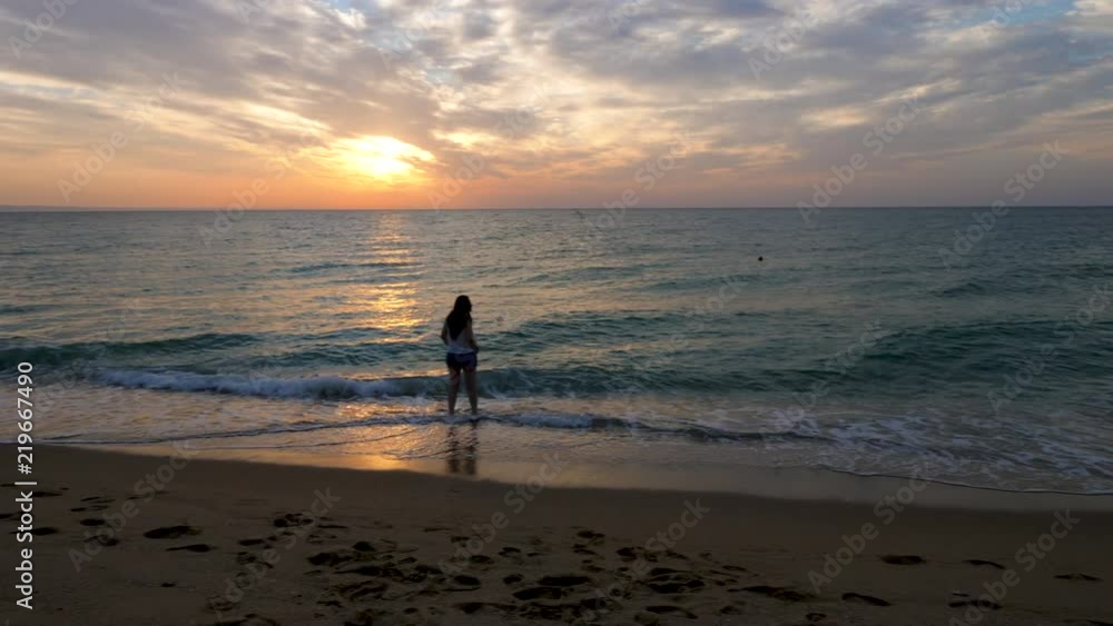 People silhouette walking on the beach at the sunrise. Travel, vacation and relaxation People silhouette walking on the beach at the sunrise. Travel, vacation and relaxation