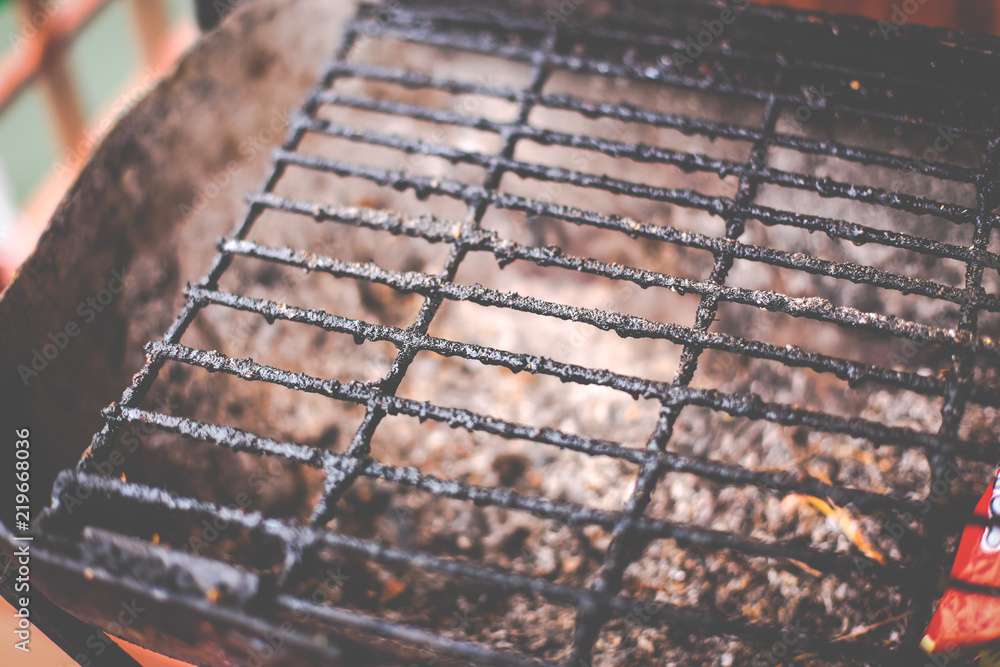 Closeup of dirty and burnt barbecue grill grates. Risk factor of