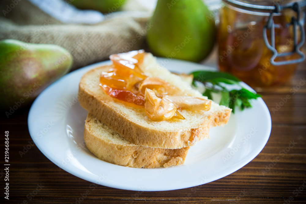 pieces of bread with sweet home-made fruit jam from pears and apples in a plate pieces of bread with sweet home-made fruit jam from pears and apples in a plate