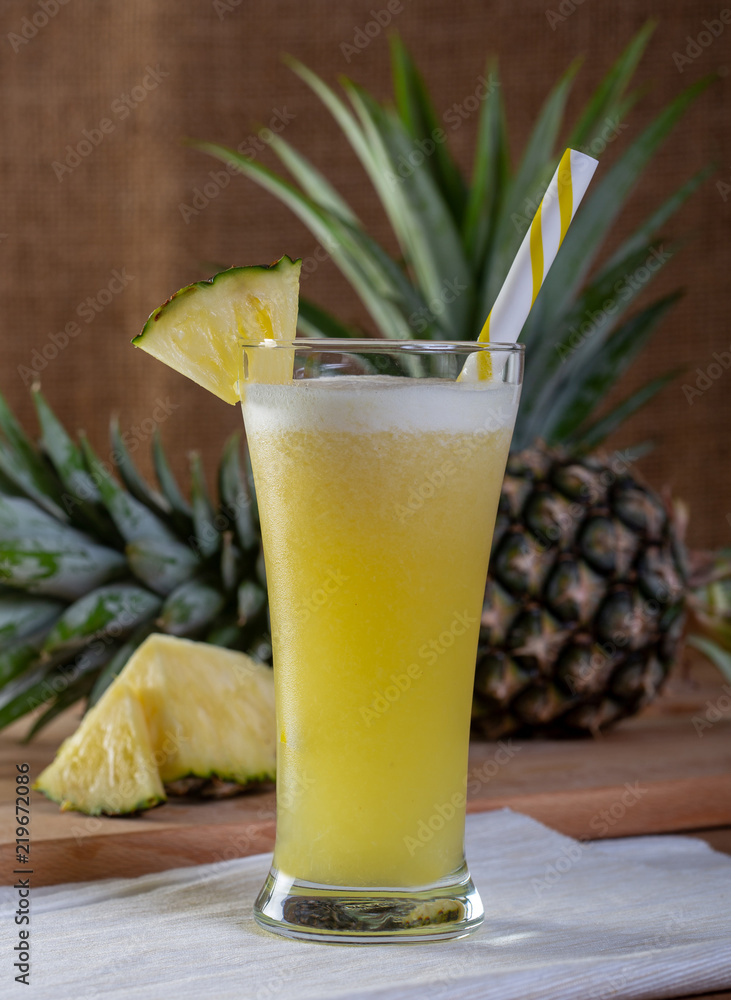 Pineapple smoothies juice on a wooden floor. Pineapple smoothies juice on a wooden floor.