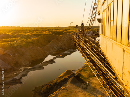 Many buckets of giant quarry excavator. Equipment for the extraction of sand from the quarry on the background 
