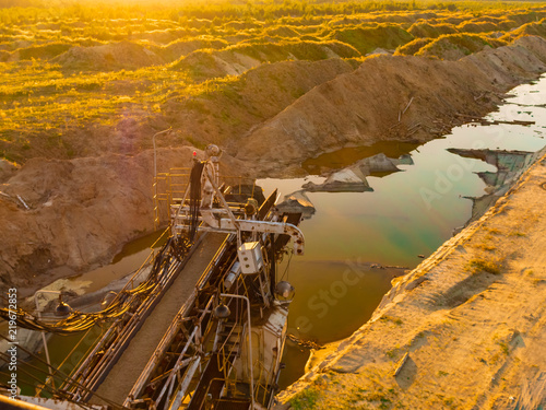 Many buckets of giant quarry excavator. Equipment for the extraction of sand from the quarry on the background 