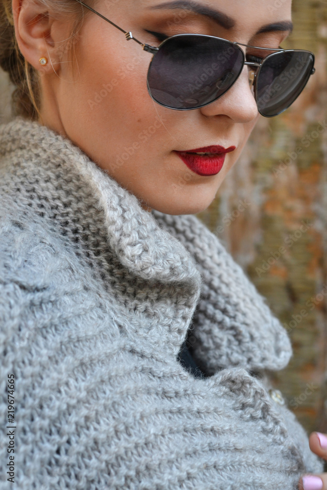 Glamorous blonde with red lips and glasses