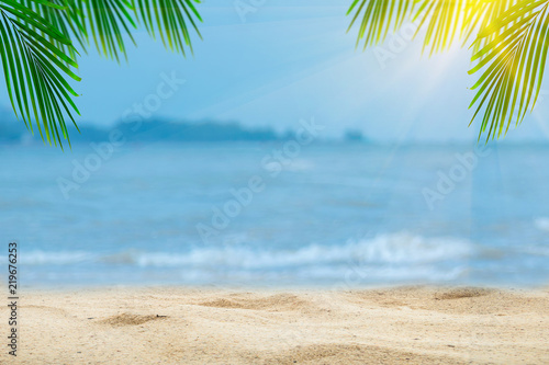 Top of wood table with blurred sea and palm tree background,Concept Summer, Beach, Sea, Relax. © A Stockphoto