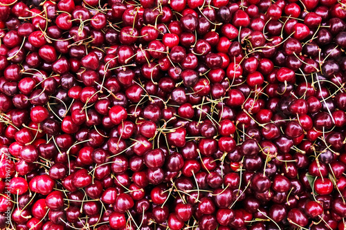 Ripe cherry with stems and leaves. Ripe cherries background.
