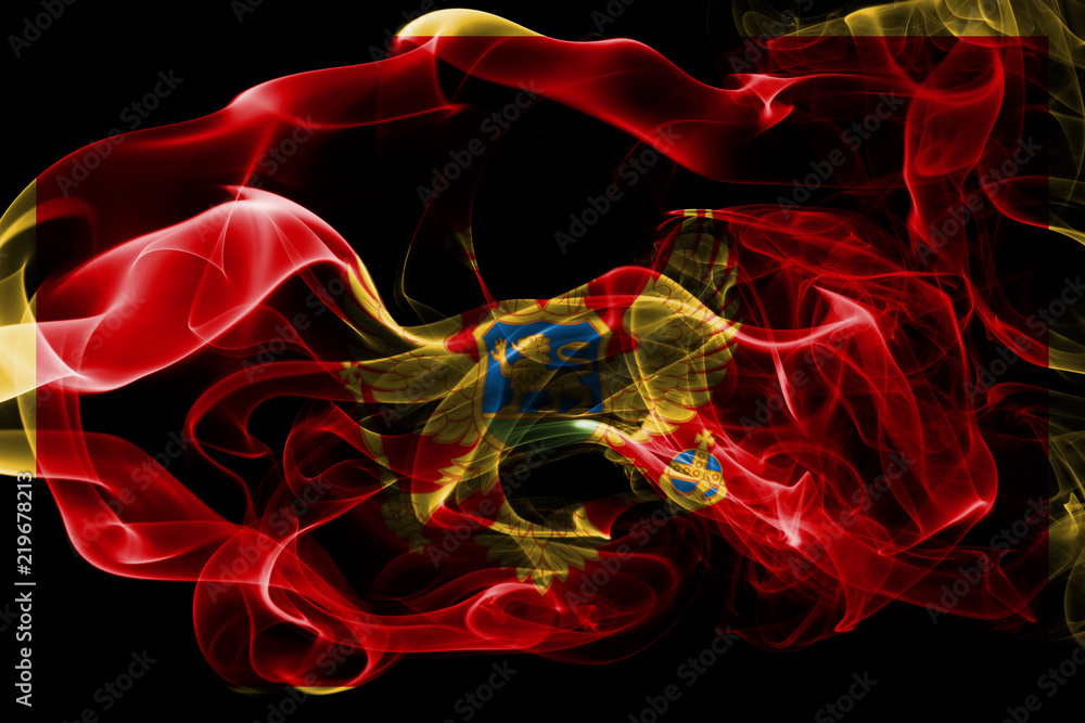 National flag of Montenegro made from colored smoke isolated on black background. Abstract silky wave background. National flag of Montenegro made from colored smoke isolated on black background. Abstract silky wave background.